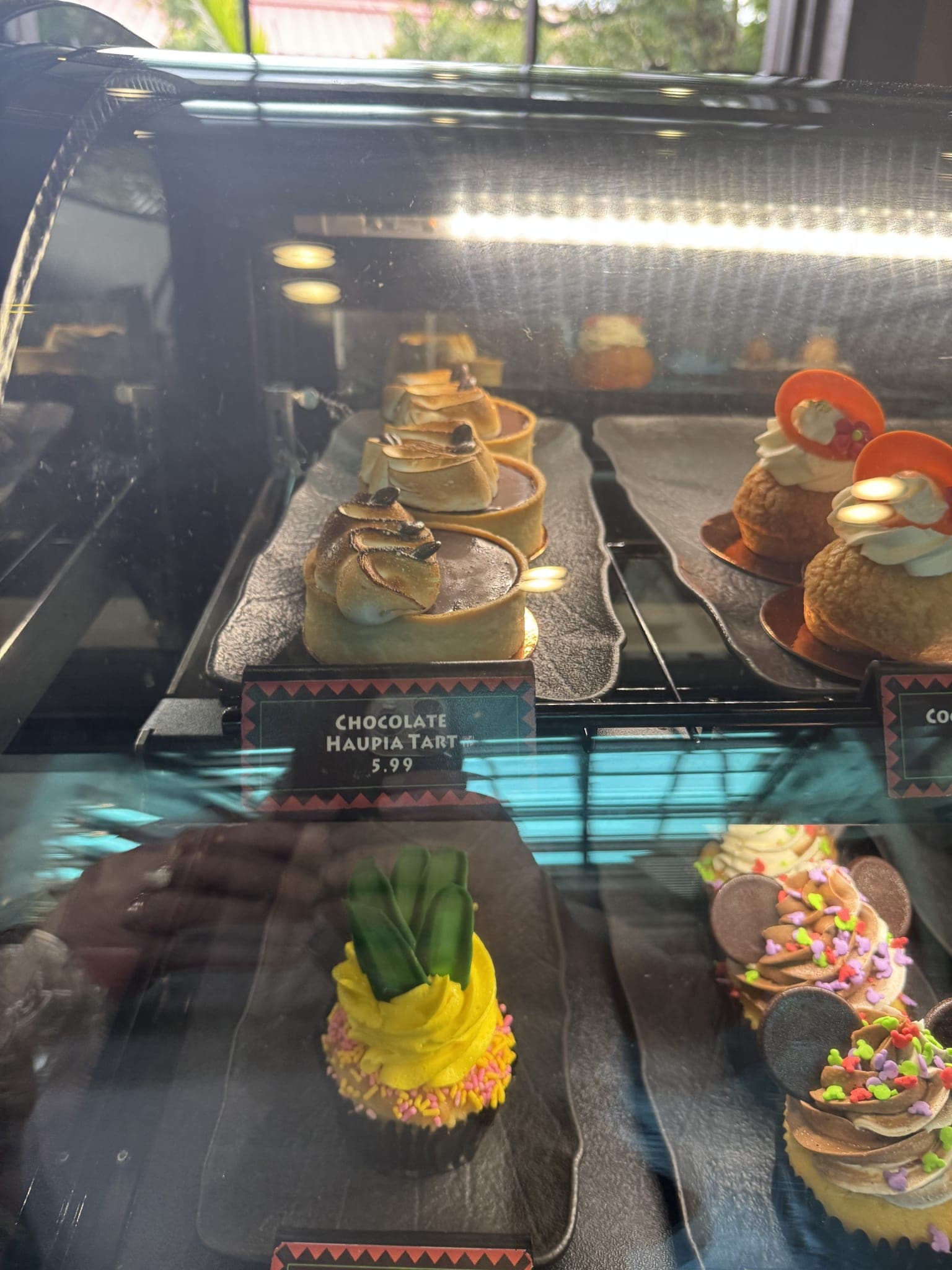Kona Island dessert case with haupia tarts, choux, and cupcakes