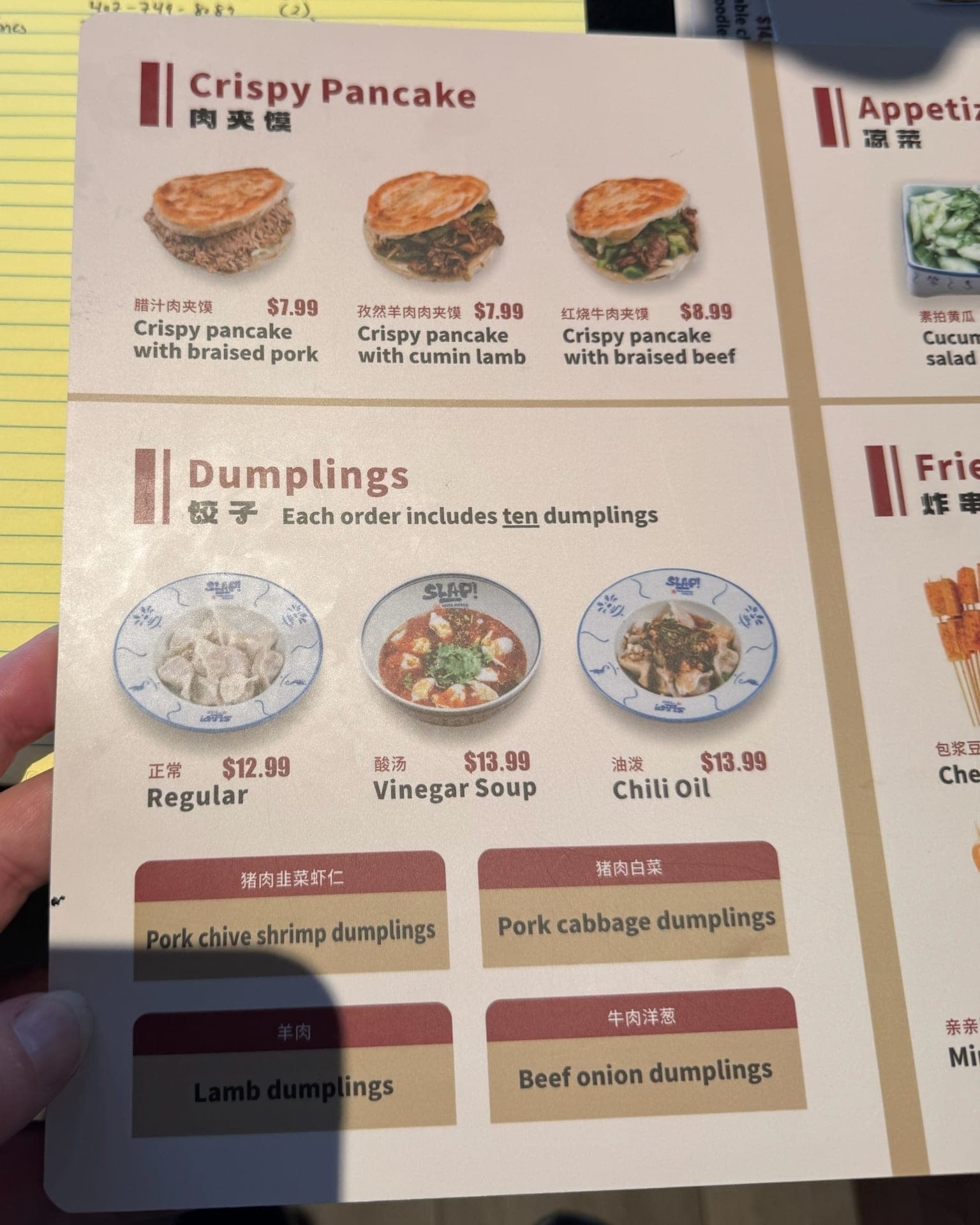 SLAP Hand-Ripped Noodles paper menu showing crispy pancake and dumpling sections with prices