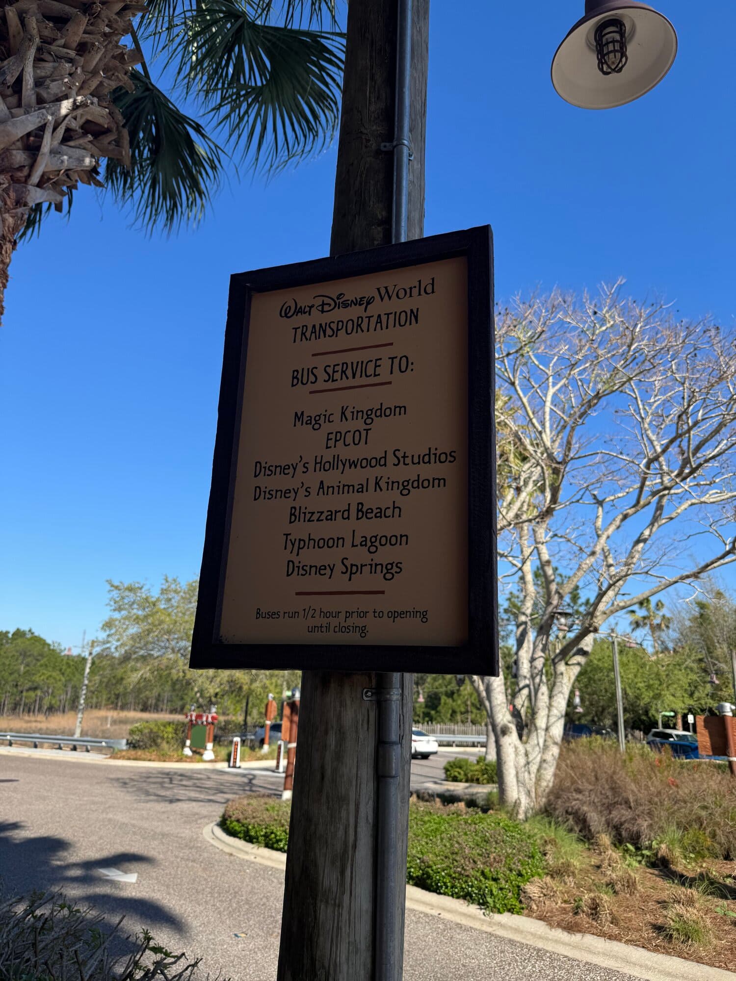Walt Disney World Transportation bus service sign at Animal Kingdom Lodge listing Magic Kingdom, EPCOT, Hollywood Studios, Animal Kingdom, Blizzard Beach, Typhoon Lagoon, and Disney Springs